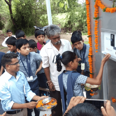 school-girl-opening-water-atm